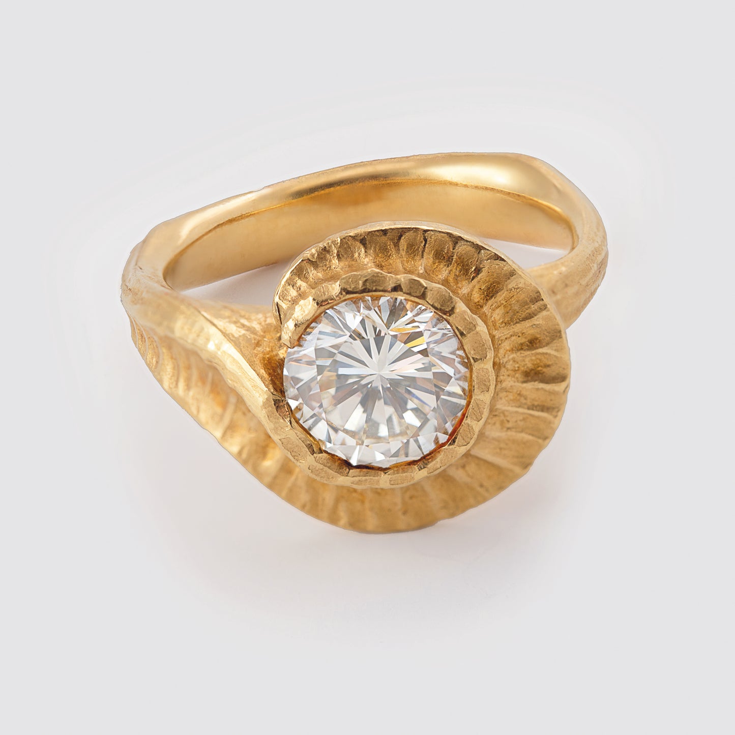 Yellow metal ring with round gem
