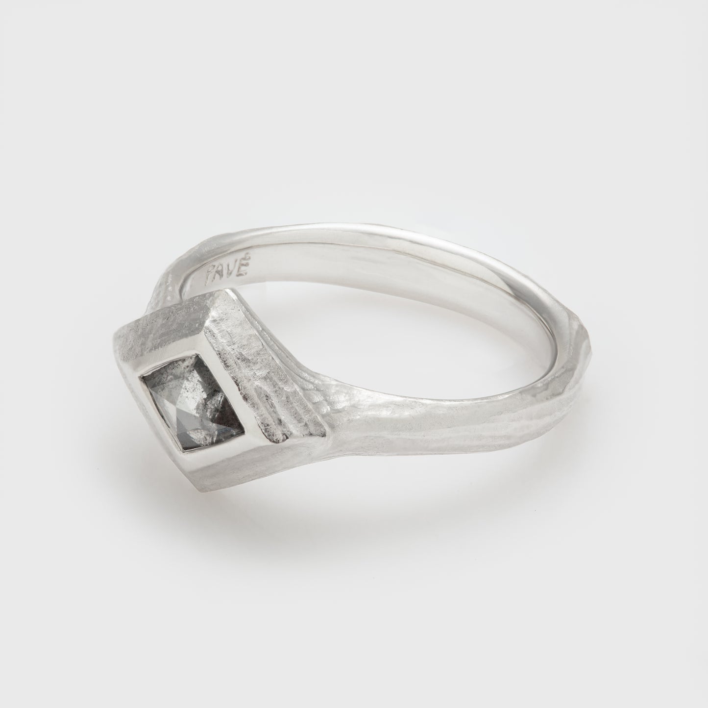 Side view of a platinum ring with rustic diamond and redwood bark textured shank.