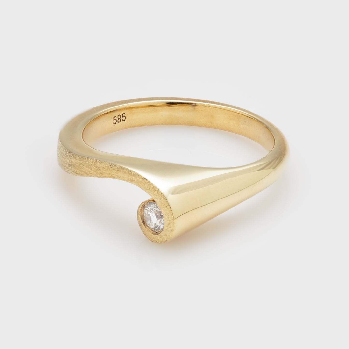 Side view of a 14k yellow gold ring with matte and polished finish and a diamond.