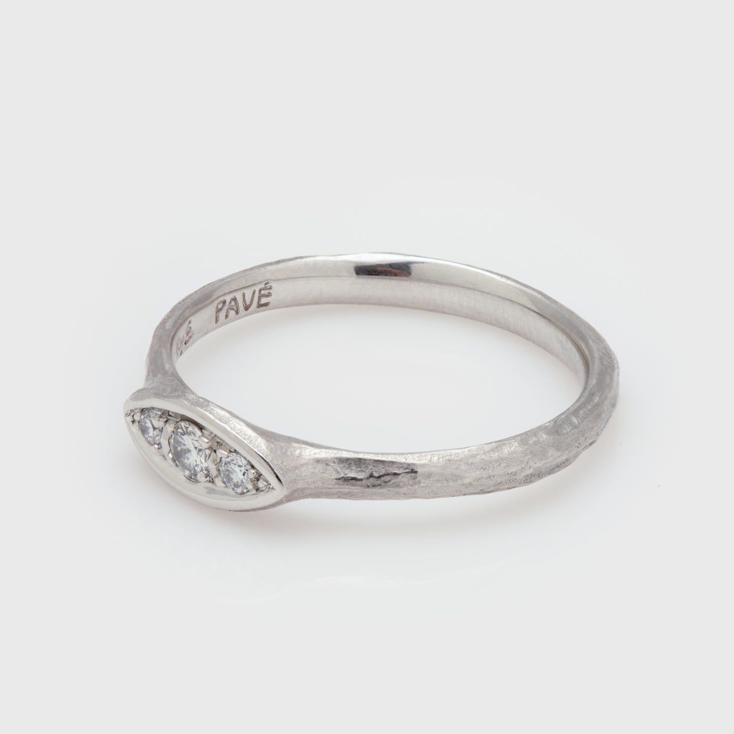 Close-up of a platinum ring with round brilliant cut diamonds.