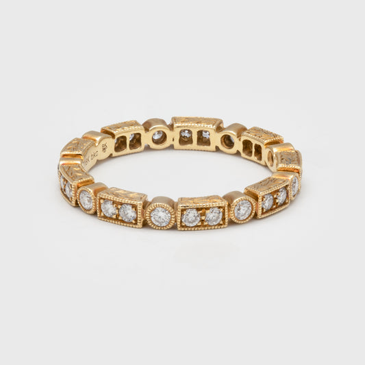 18k gold eternity band featuring round and baguette diamonds.