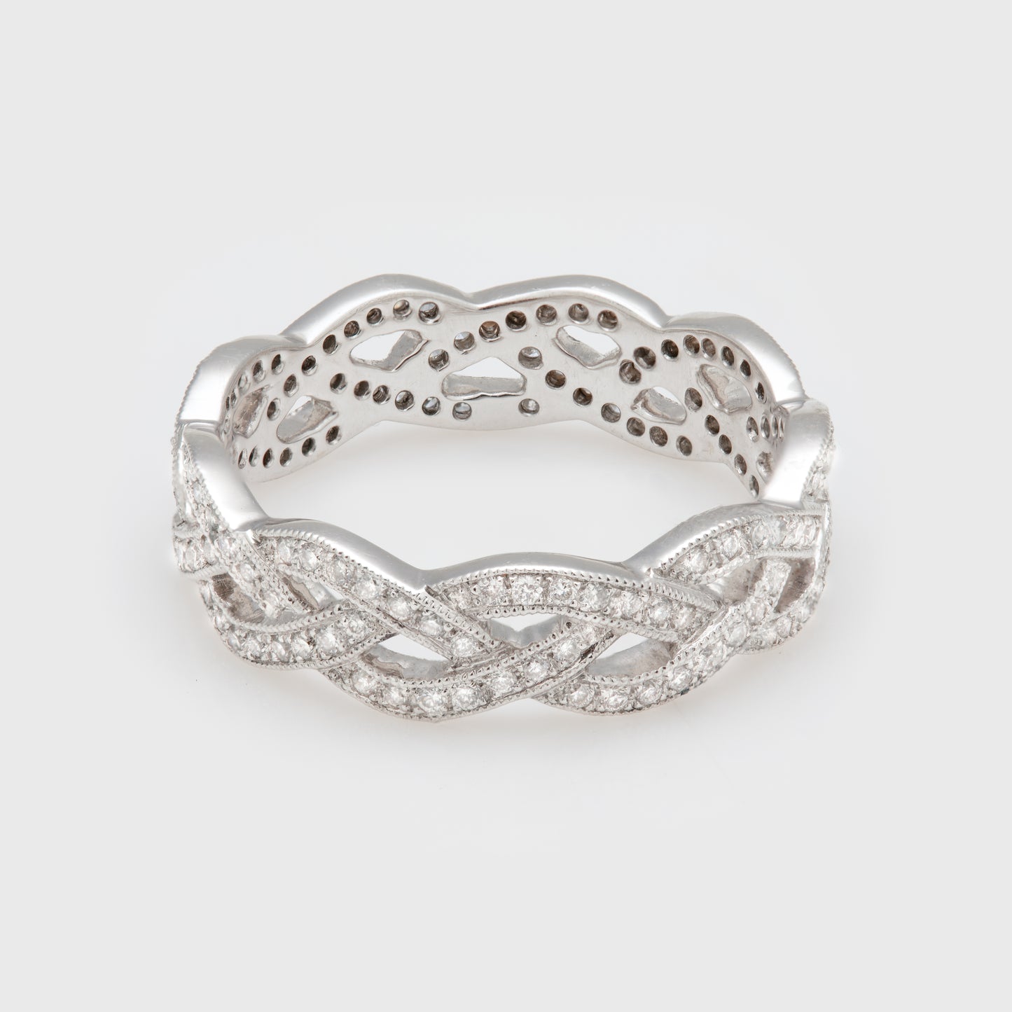 Close-up of an 18k white gold braided band with diamonds.