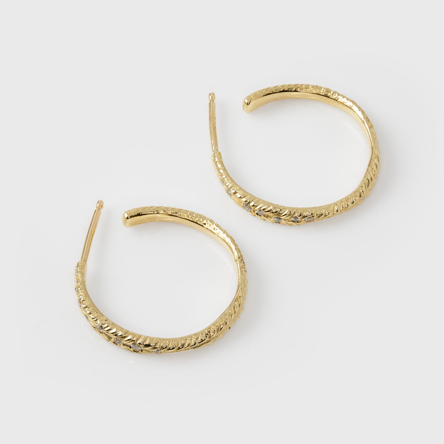 Gold hoop earrings on a white background