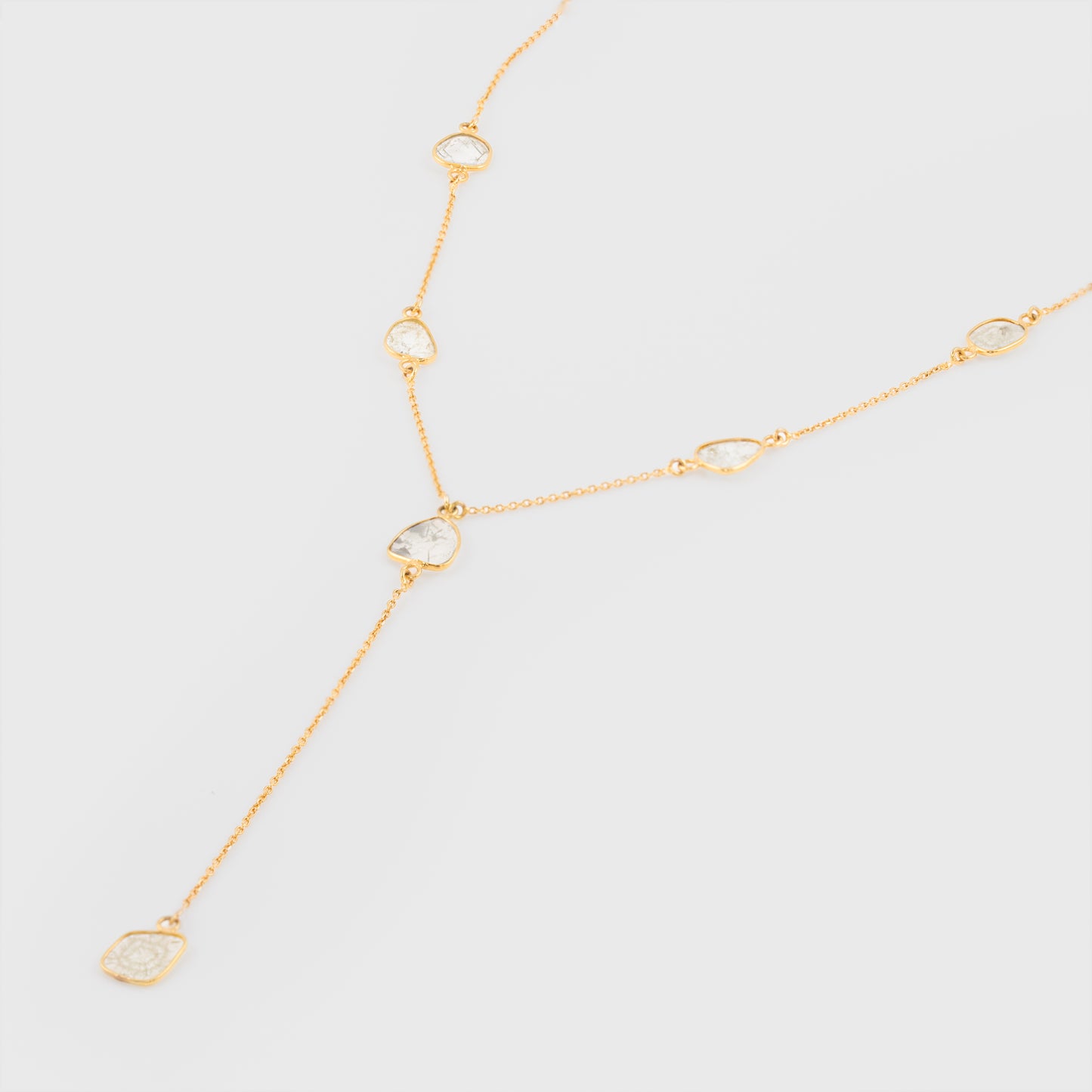 Close-up of an 18k yellow gold necklace with diamond slices.