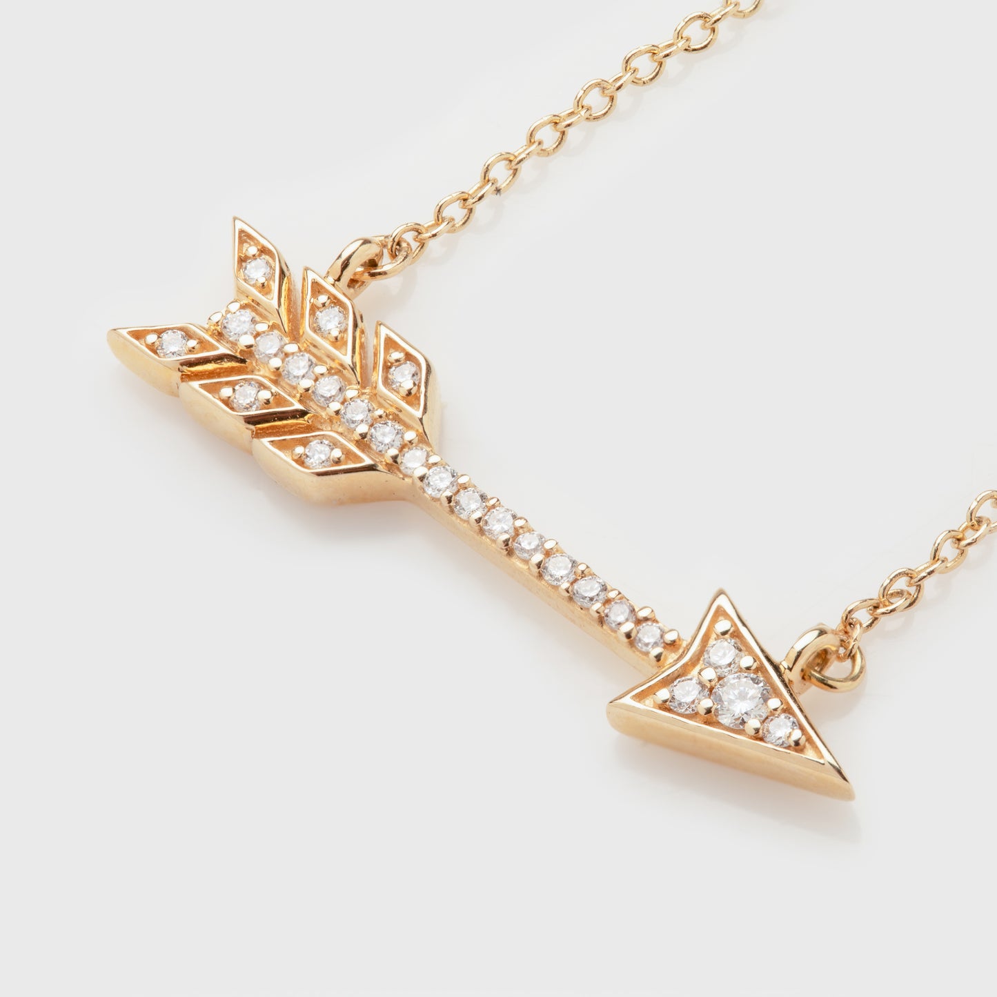 Close-up of a 14k yellow gold necklace with diamonds.