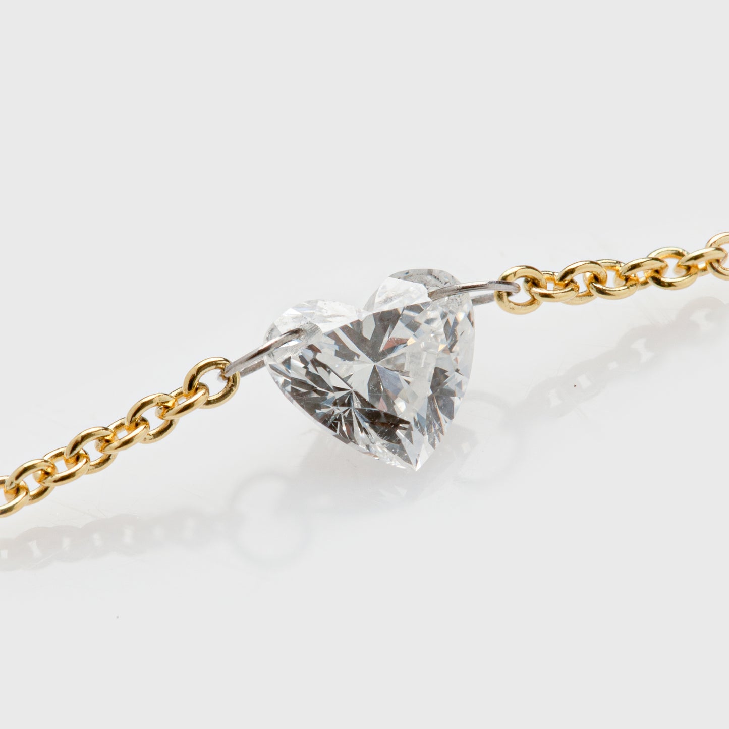 Close-up of a 14k yellow gold necklace with a heart-shaped diamond.
