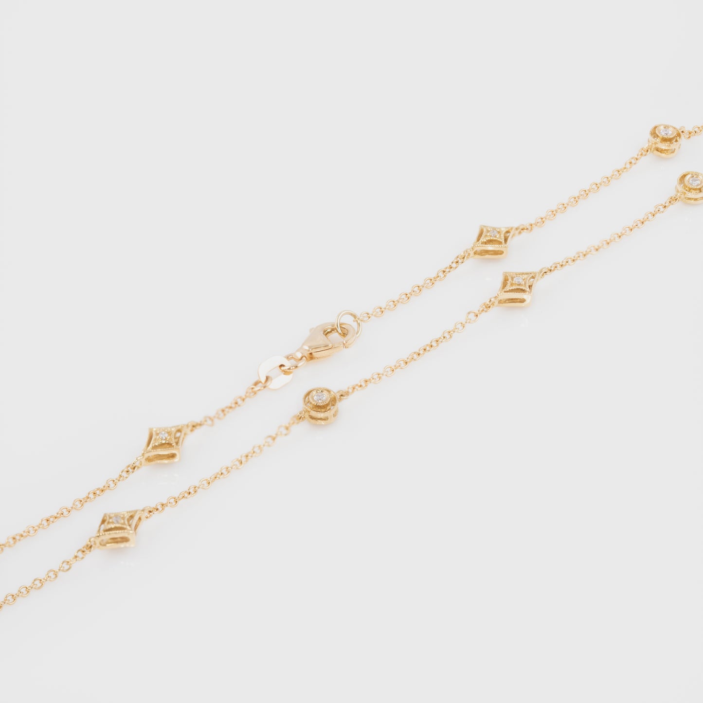 Close-up of a diamond chain necklace in 18k yellow gold.