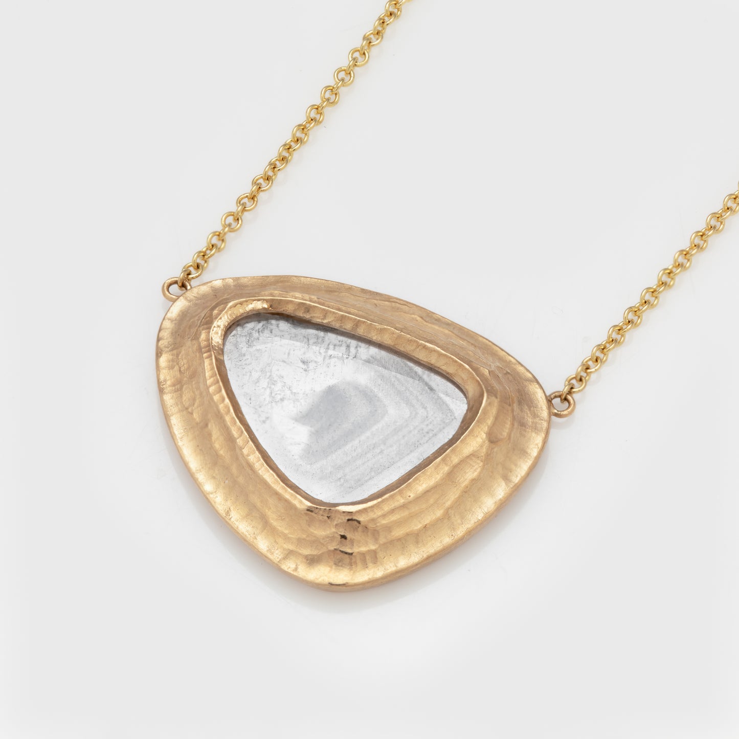 Front view of an 18k yellow gold necklace with diamond slice gem.