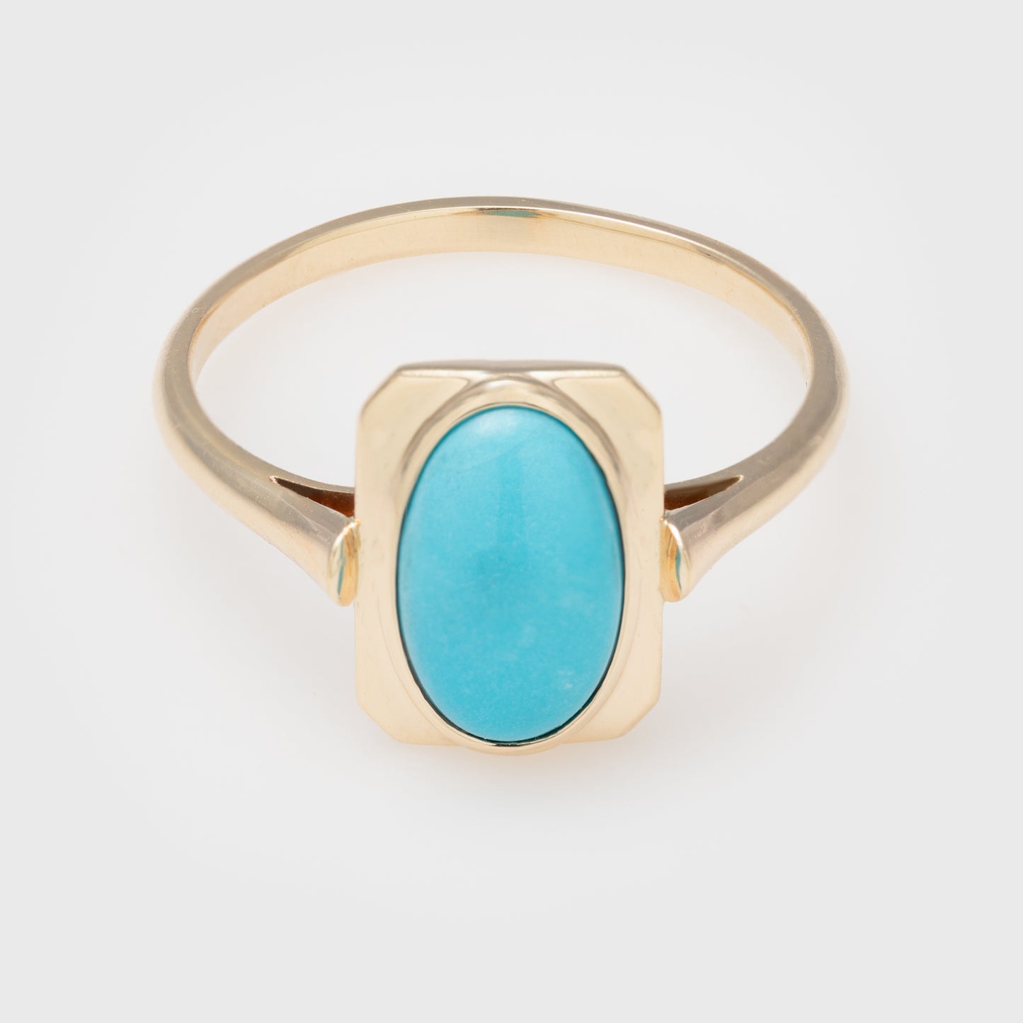 Yellow gold ring with oval turquoise cabochon in a rectangular setting