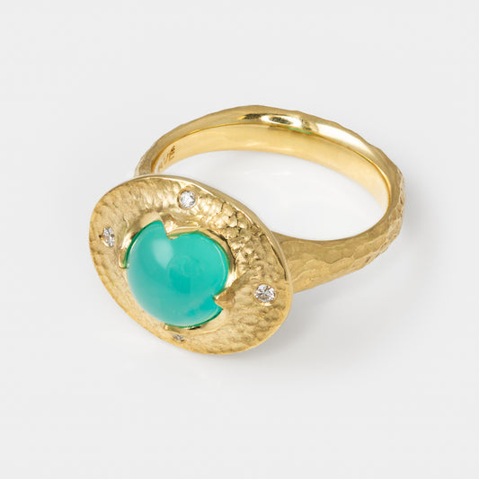 Gold ring with a chrysocolla gemstone and small diamonds on a white background