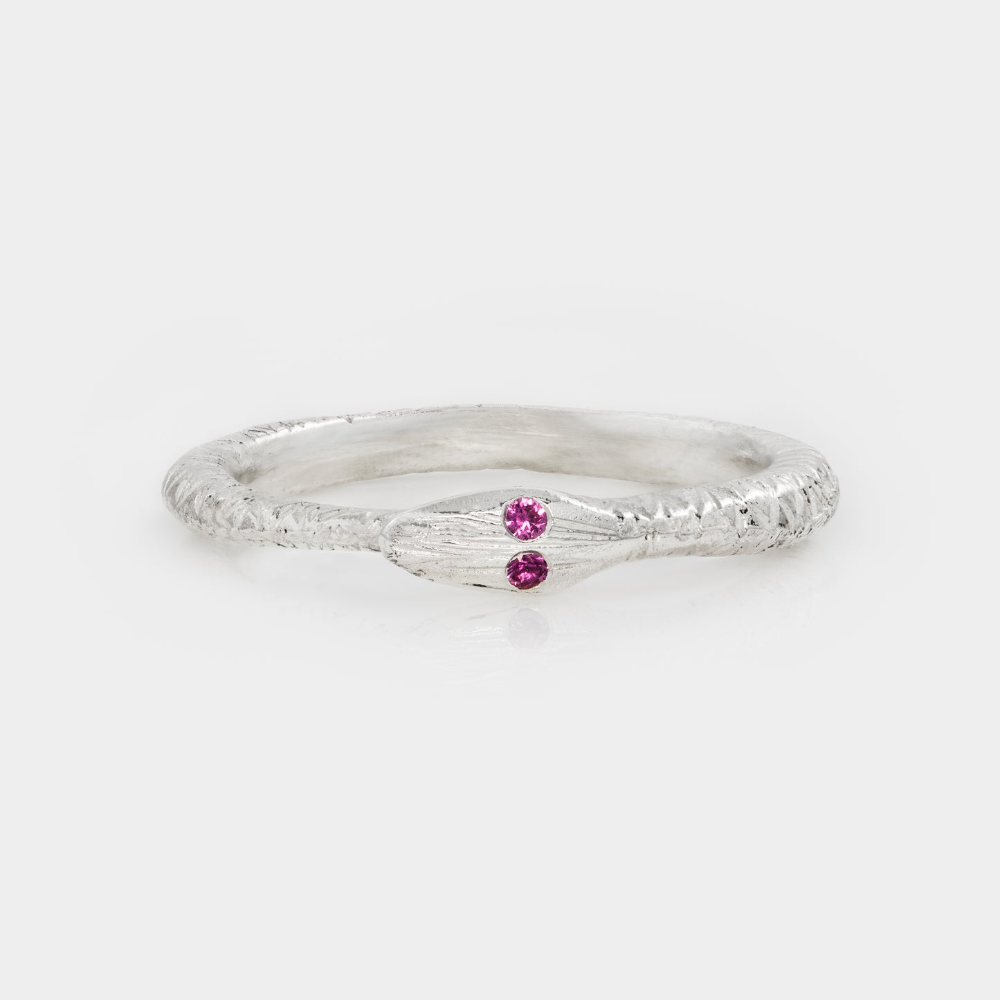 Silver ring with two pink gemstones on a white background