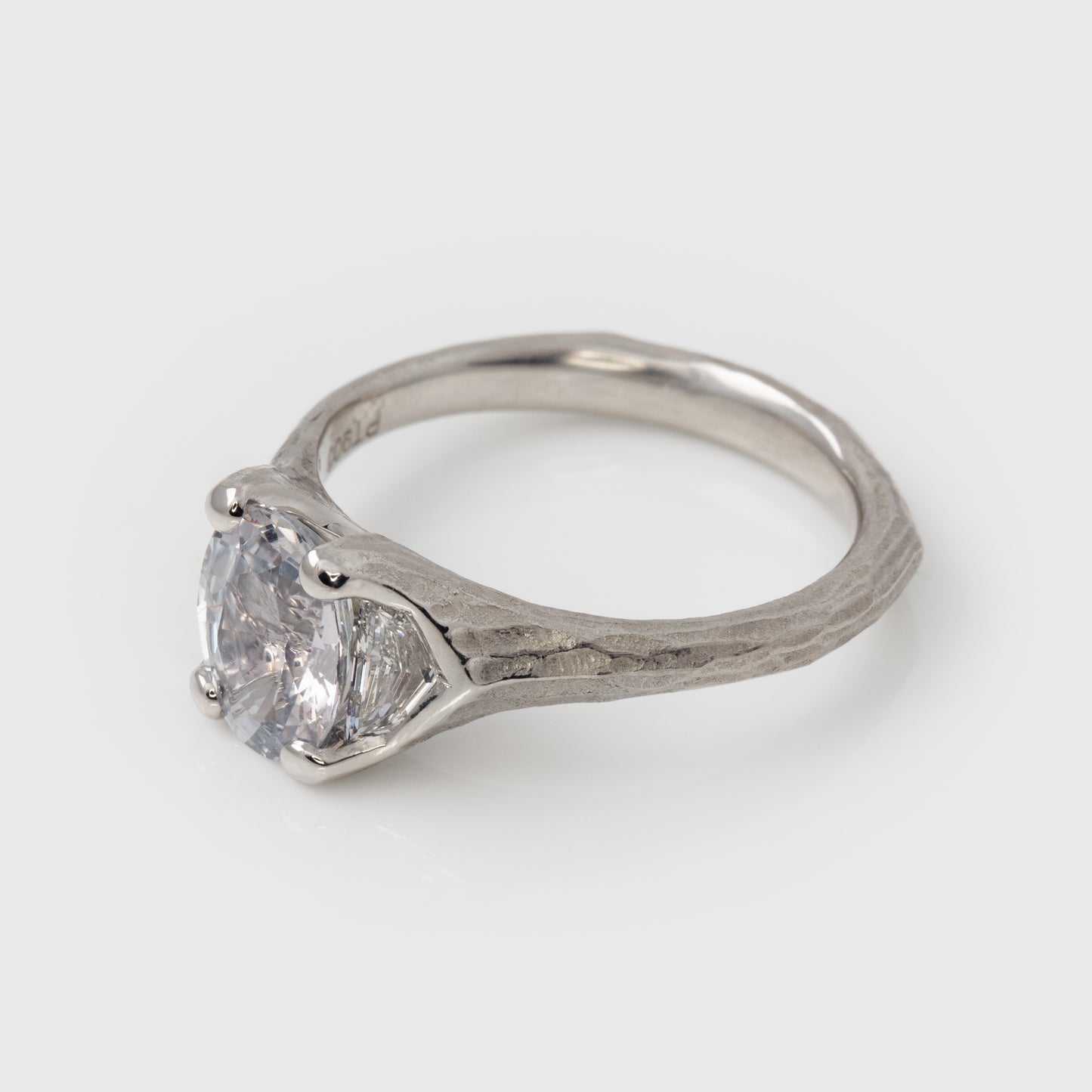 Platinum ring with a large gemstone on a white background