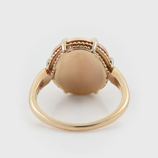 Back view of Tri-color gold ring showcasing textured backing of center stone photographed on a white background.