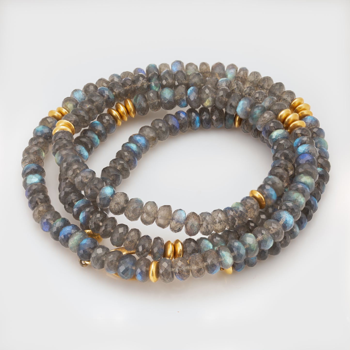Close-up of an 18k and 22k yellow gold necklace with labradorite and 22k yellow gold knife edge beads.