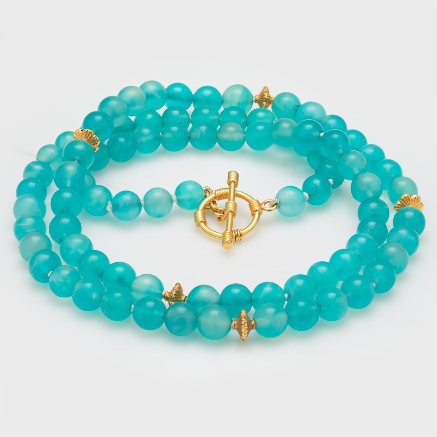 Close-up of an amazonite necklace with 18k yellow gold spacer beads and handmade 18k yellow gold.