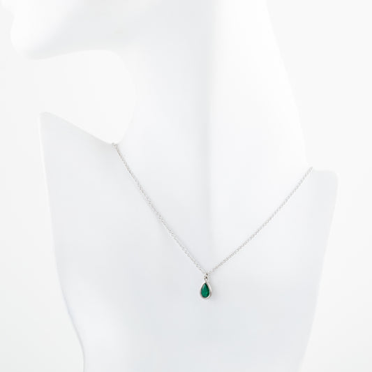 Platinum necklace with a green teardrop gem pendant on a white mannequin