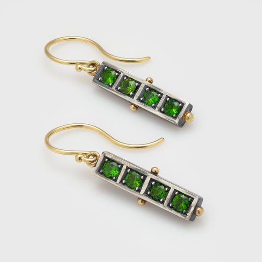 Pair of green gemstone earrings with gold and silver accents.