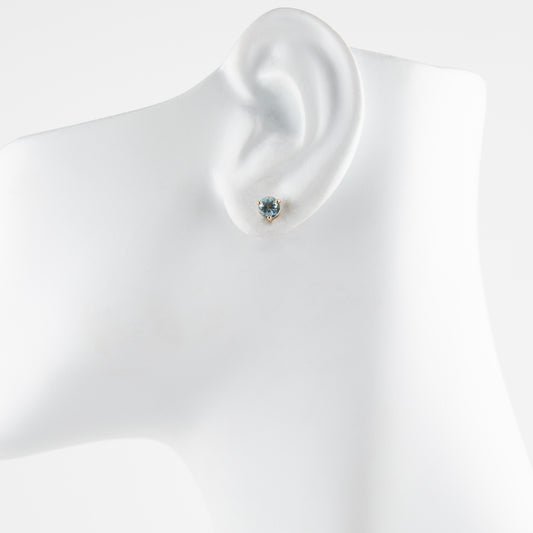 Aquamarine earring on a mannequin ear with a plain background