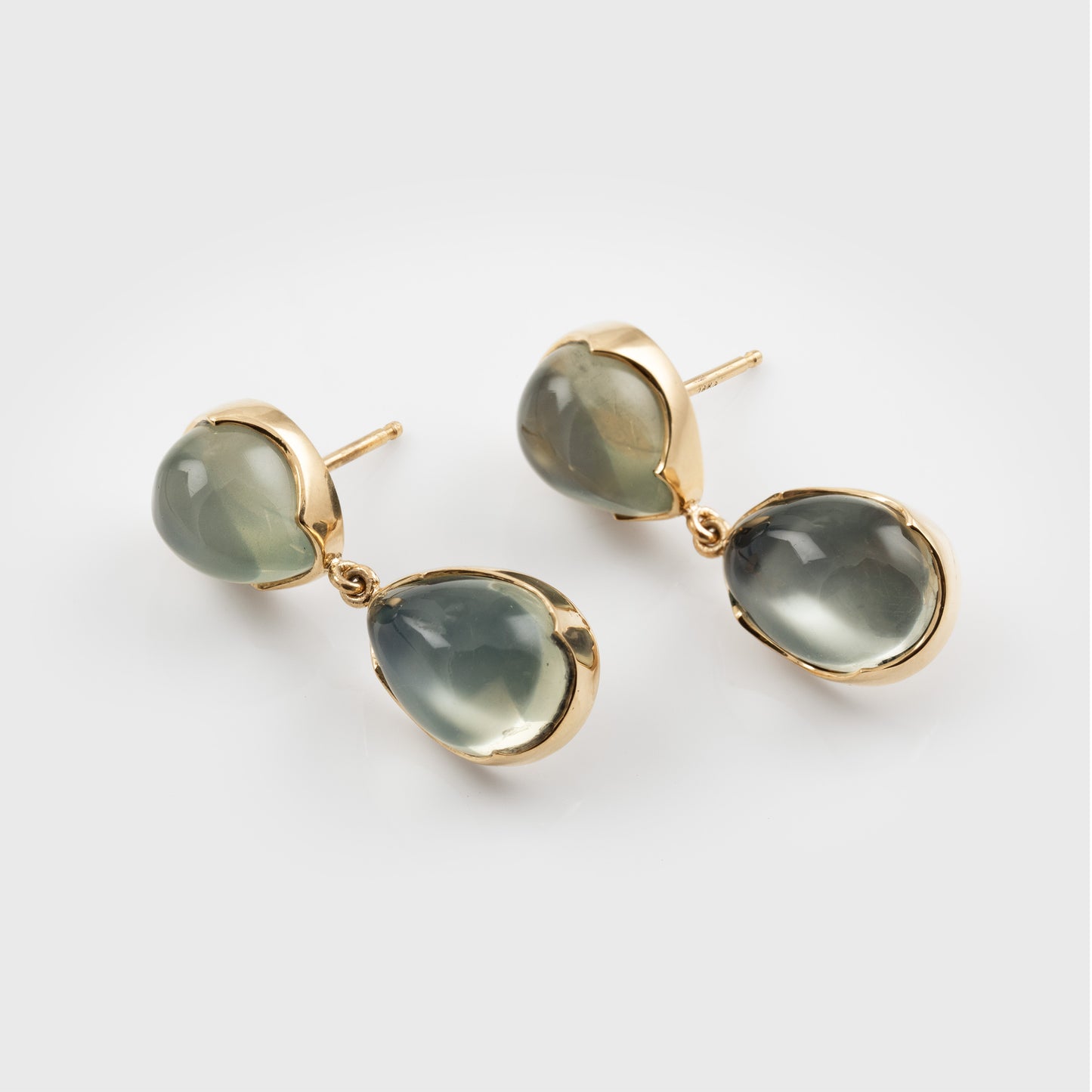 Green moonstone gemstone earrings on a white background