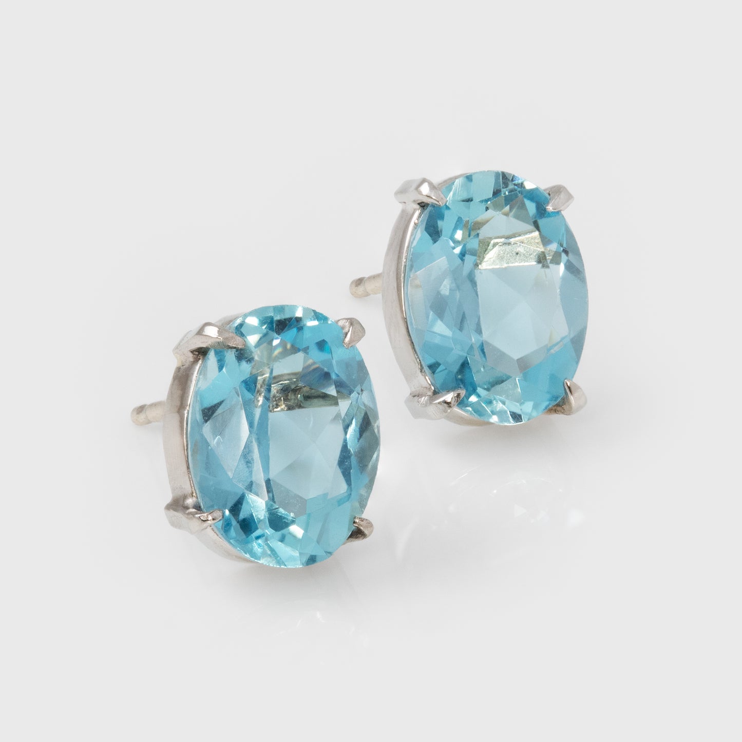 Pair of blue gemstone earrings on a light gray background