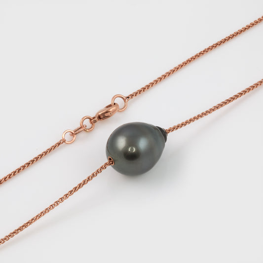 Rose gold chain necklace with a dark grey pearl pendant.