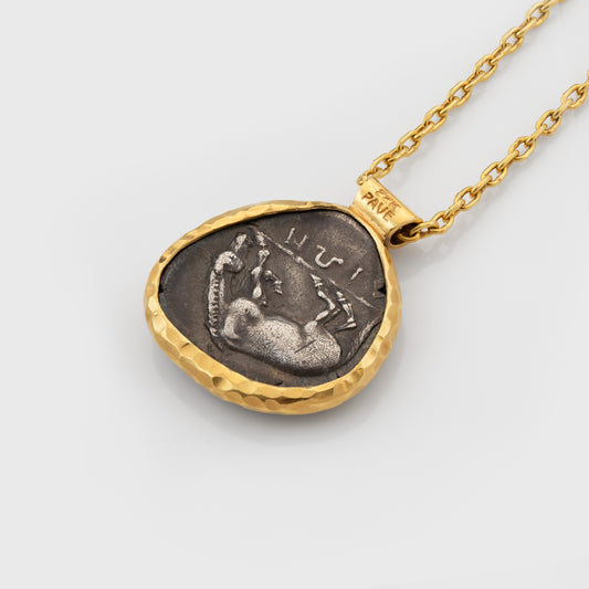 Gold necklace with an ancient coin pendant depicting a horse on a light gray background