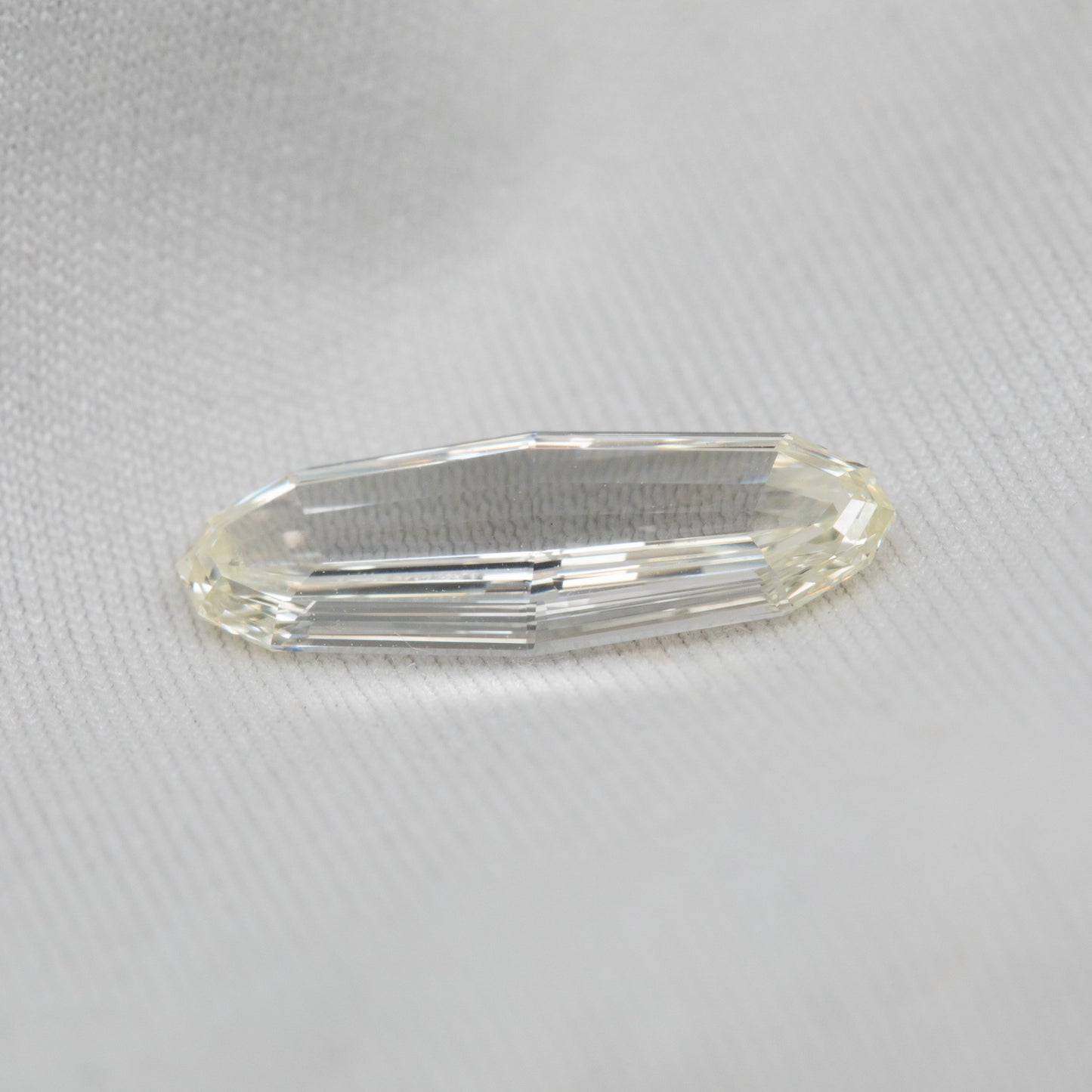 Clear diamond on a white fabric background
