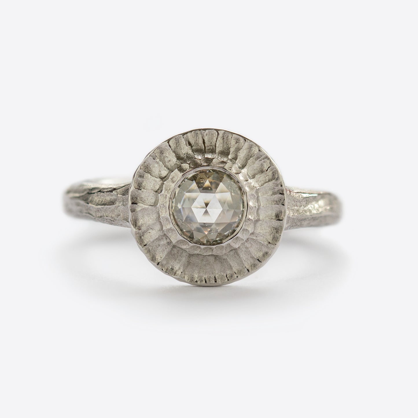 White metal ring with round gem