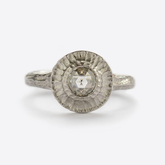 White metal ring with round gem