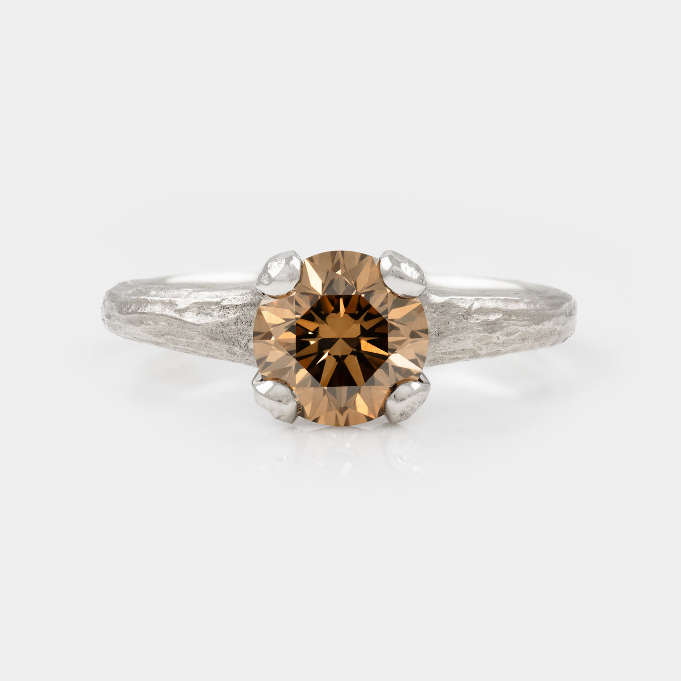 Redwood bark texture platinum band with cognac diamond on white background