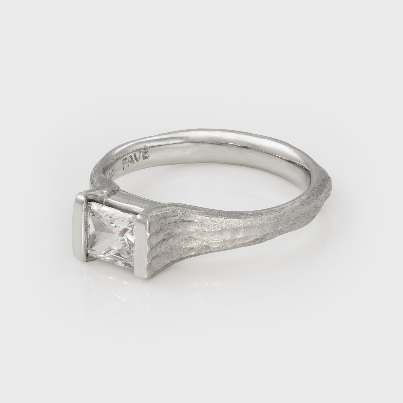Platinum ring with a diamond on a white background