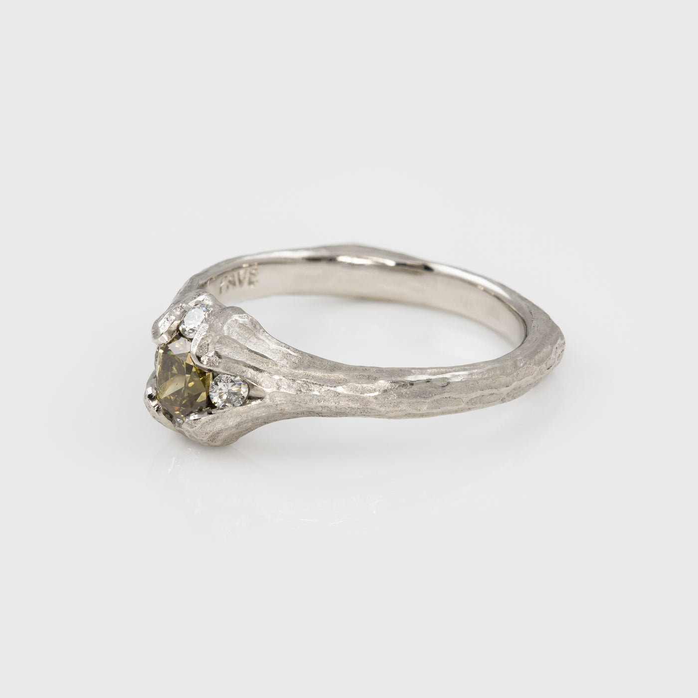 Platinum ring with yellow-brown diamond and redwood bark texture on a white background, three-fourths view