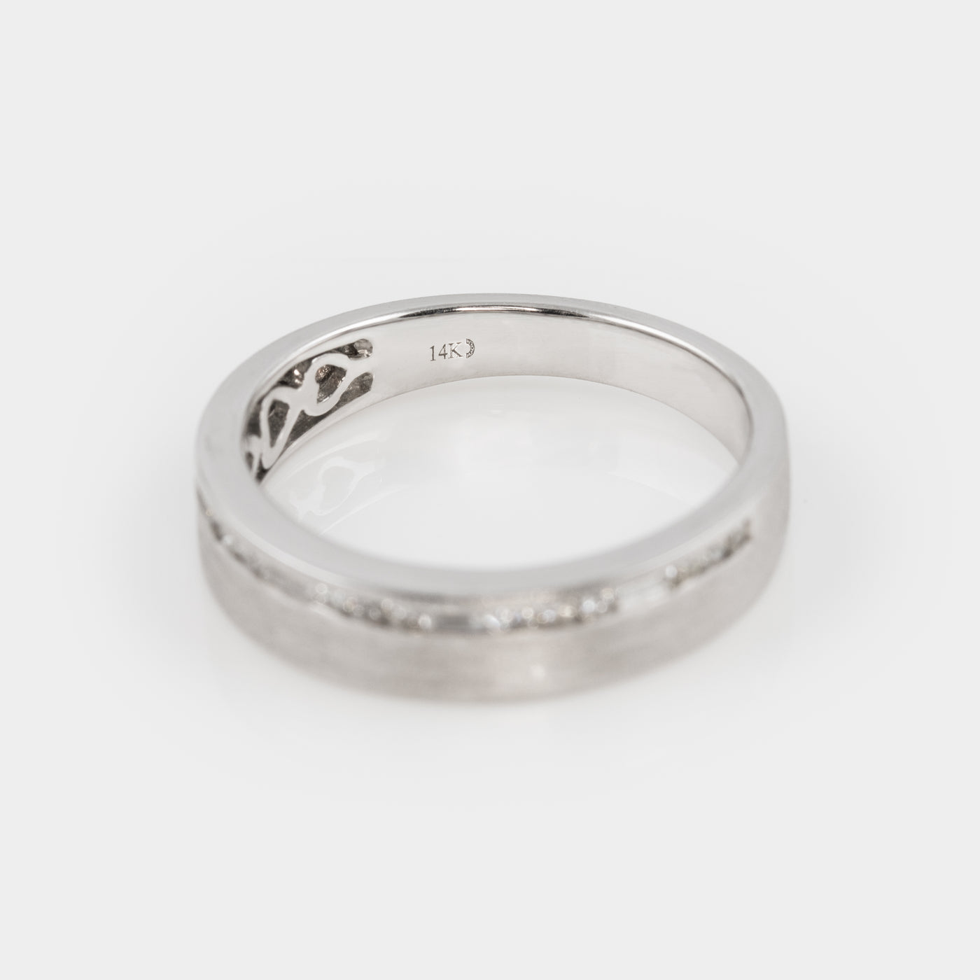 Silver ring with a subtle design on a white background