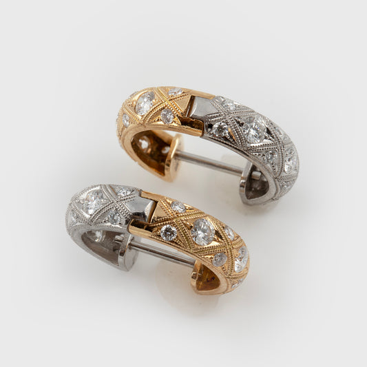 Reversible two-tone hoop earrings featuring diamonds and hand-engraved details with both gold and silver accents, photographed on a white background.