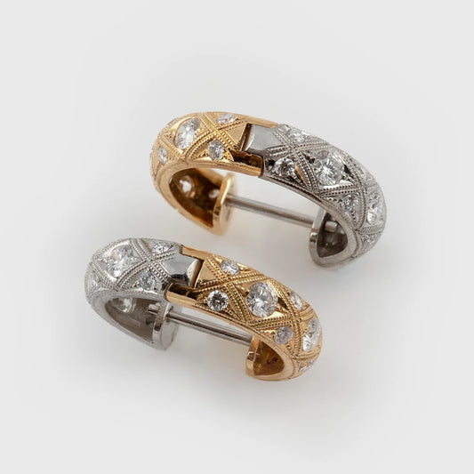 Reversible two-tone hoop earrings featuring diamonds and hand-engraved details with both gold and silver accents, photographed on a white background.