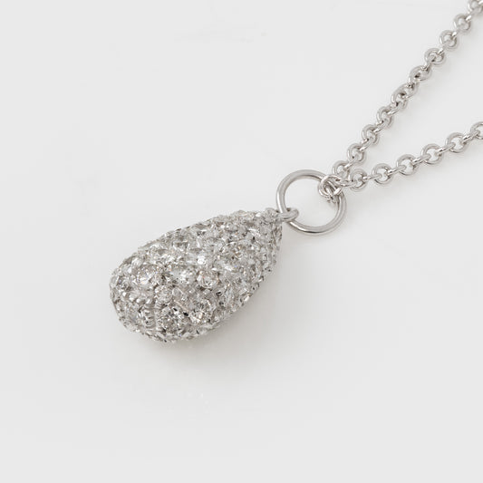 Silver teardrop pendant necklace with diamonds on a white background