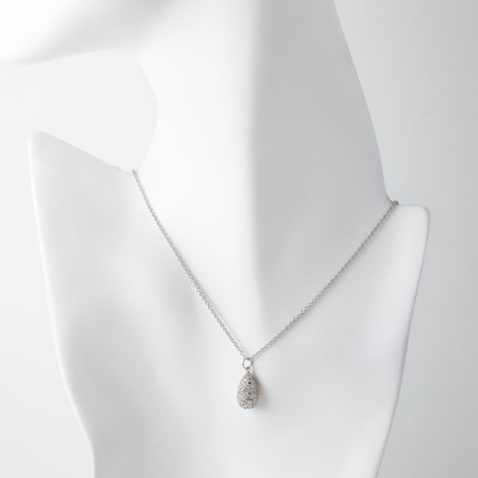 Silver teardrop pendant necklace with diamonds on a white mannequin