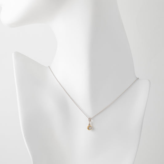 Gold necklace on a mannequin with a white background