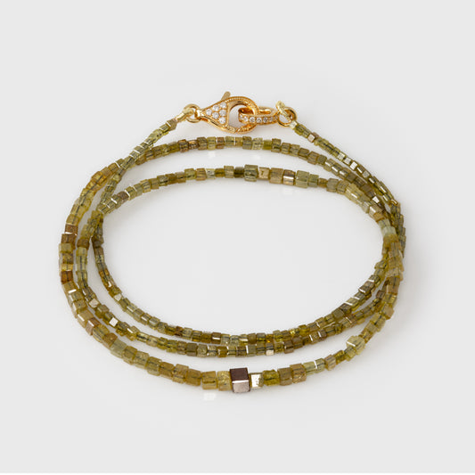 Green beaded necklace with gold clasp on a white background