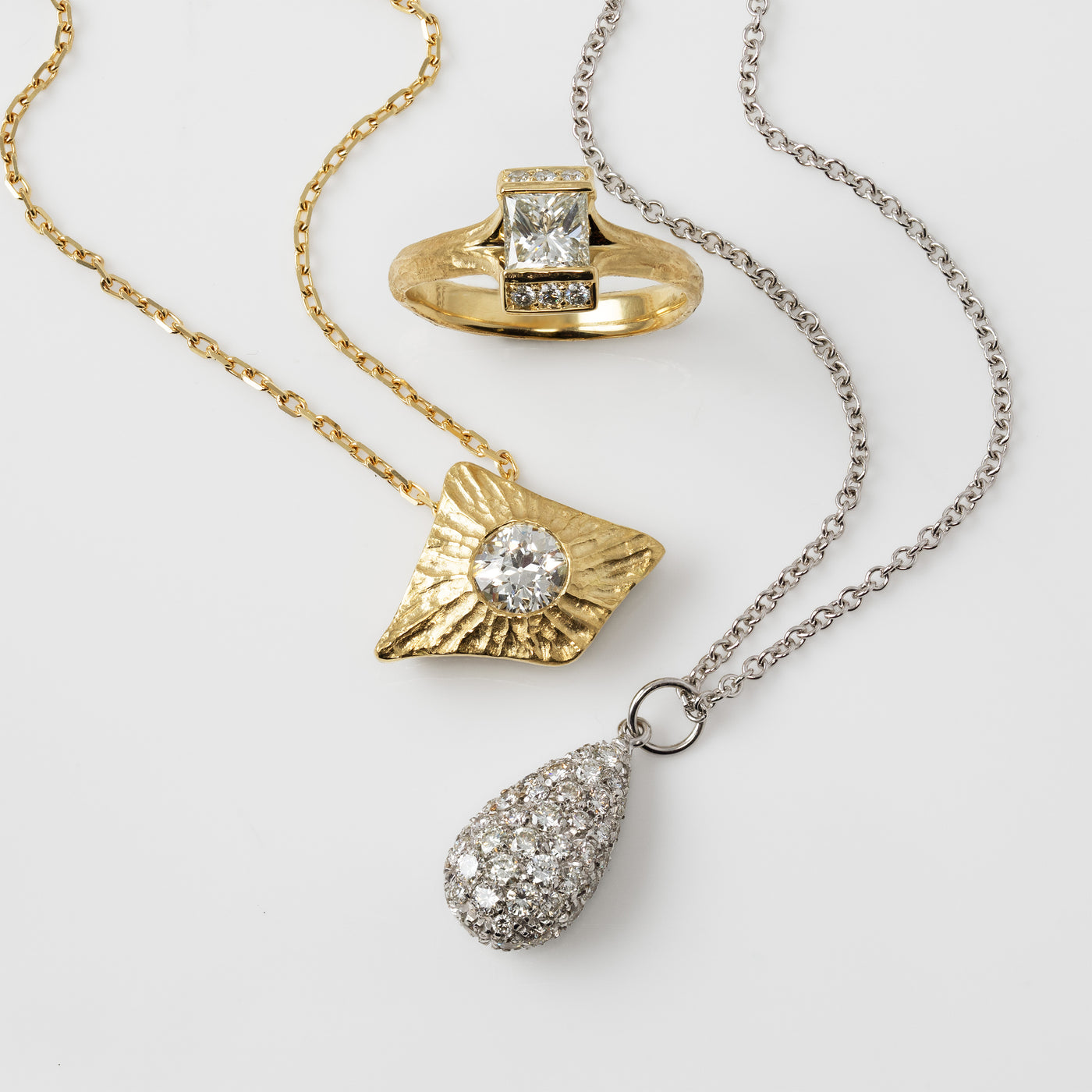 Gold ring and pendants on a white background