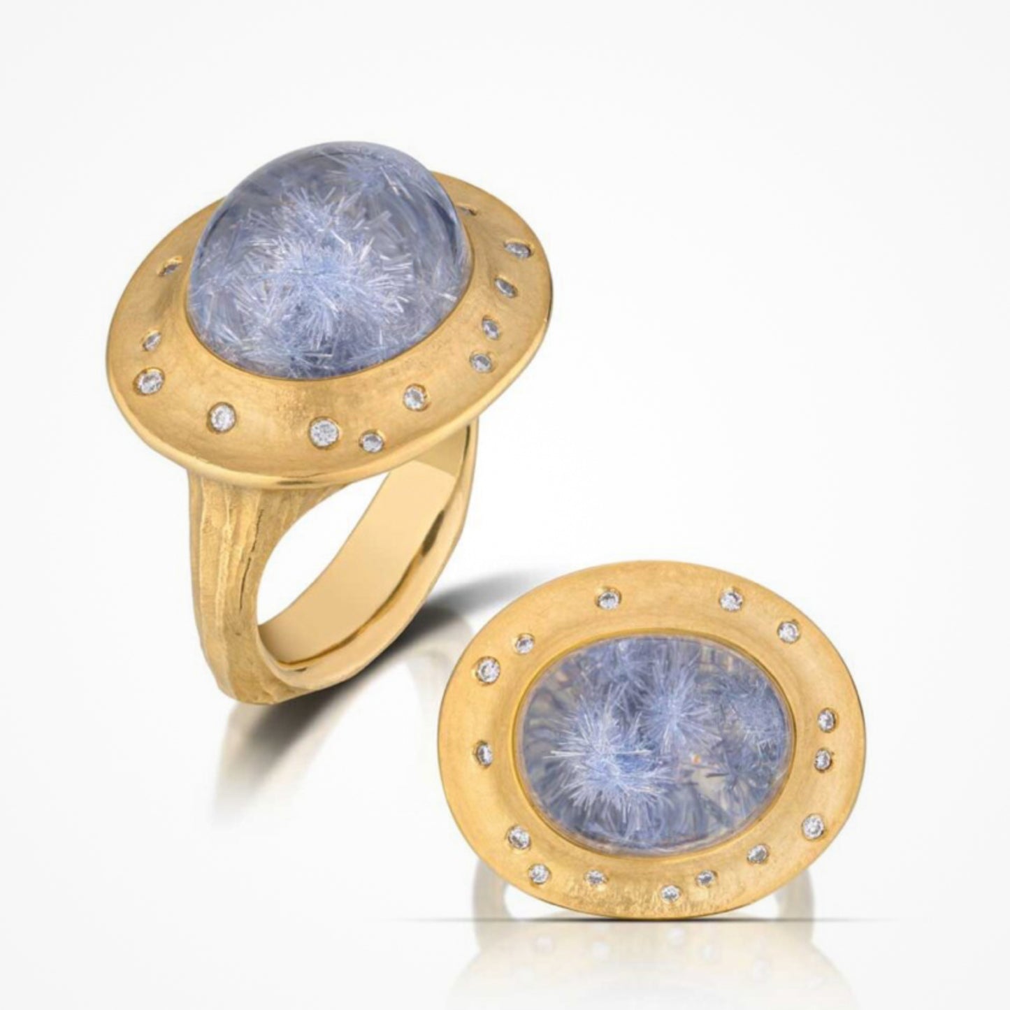 A yellow gold ring with a blue dumortierite gemstone and diamond accents.