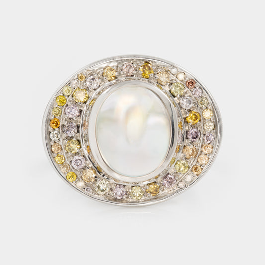 Front view of platinum ring with a central moonstone surrounded by multicolored diamonds on a white background