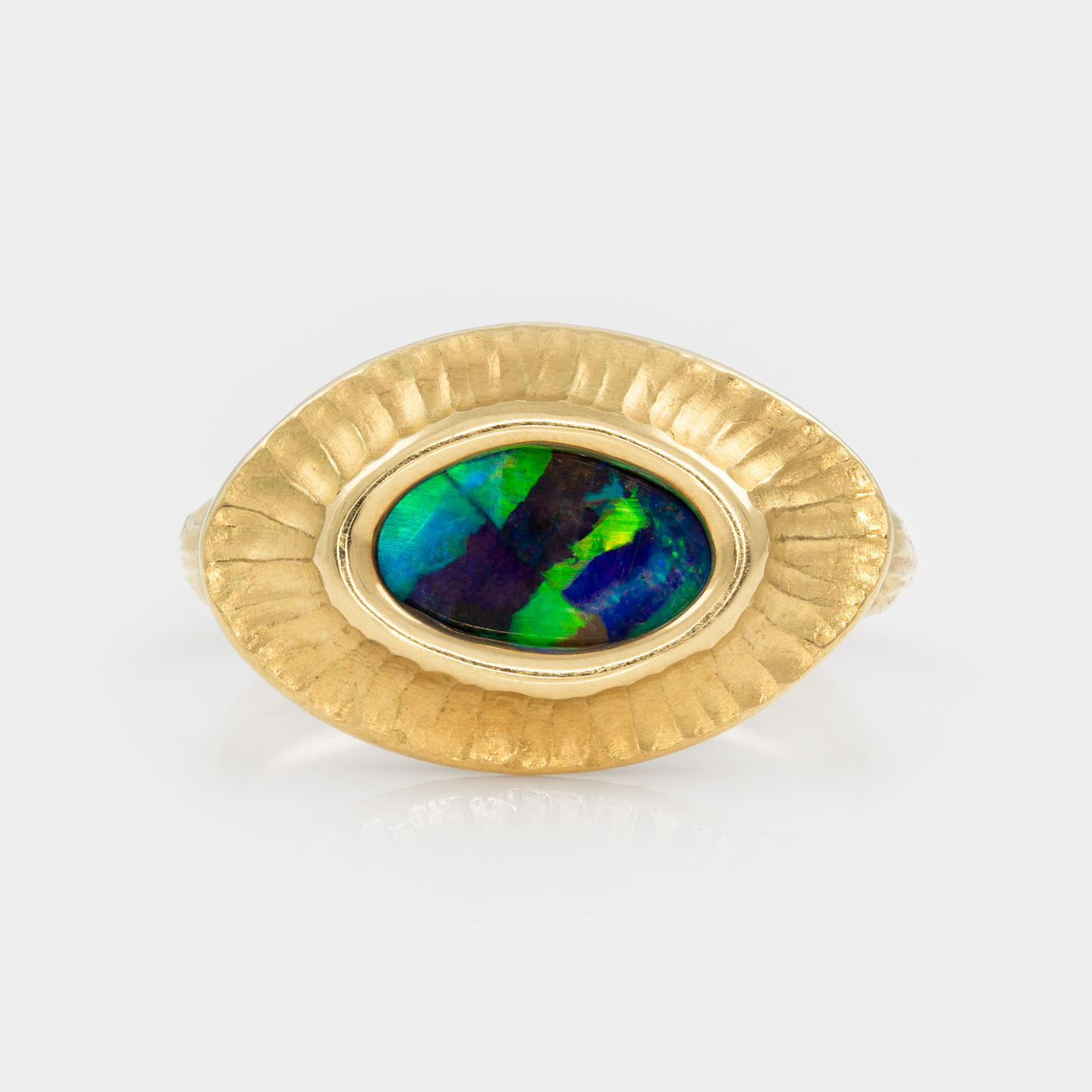 Gold ring with an opal stone on a white background