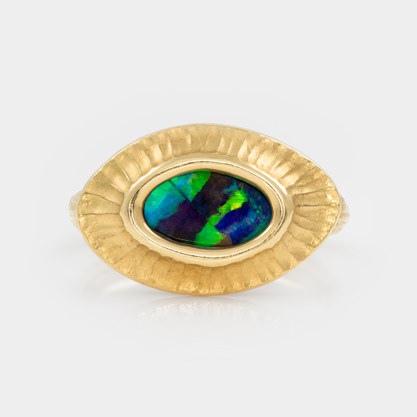 Gold ring with an opal stone on a white background