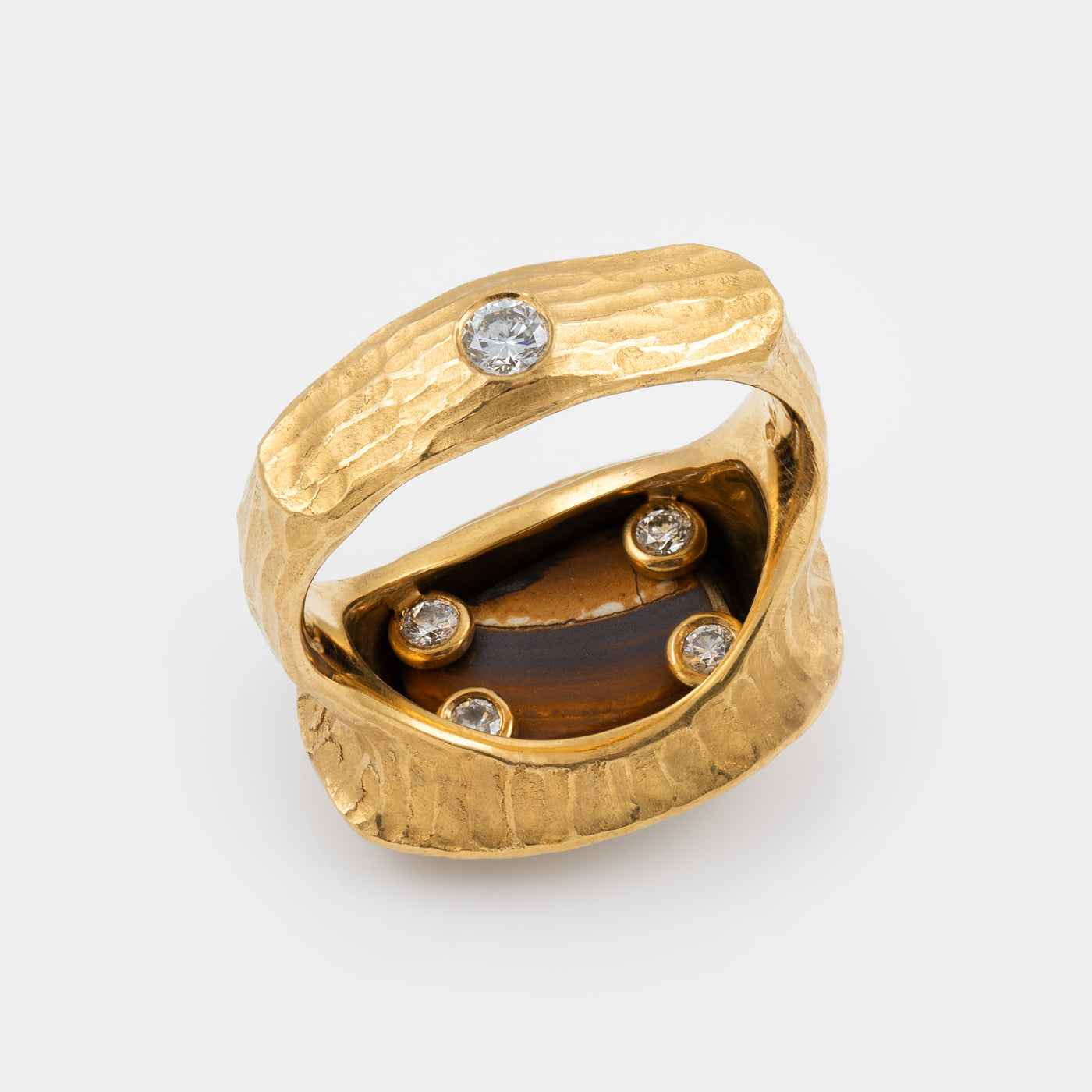 Gold ring with embedded diamonds on a white background