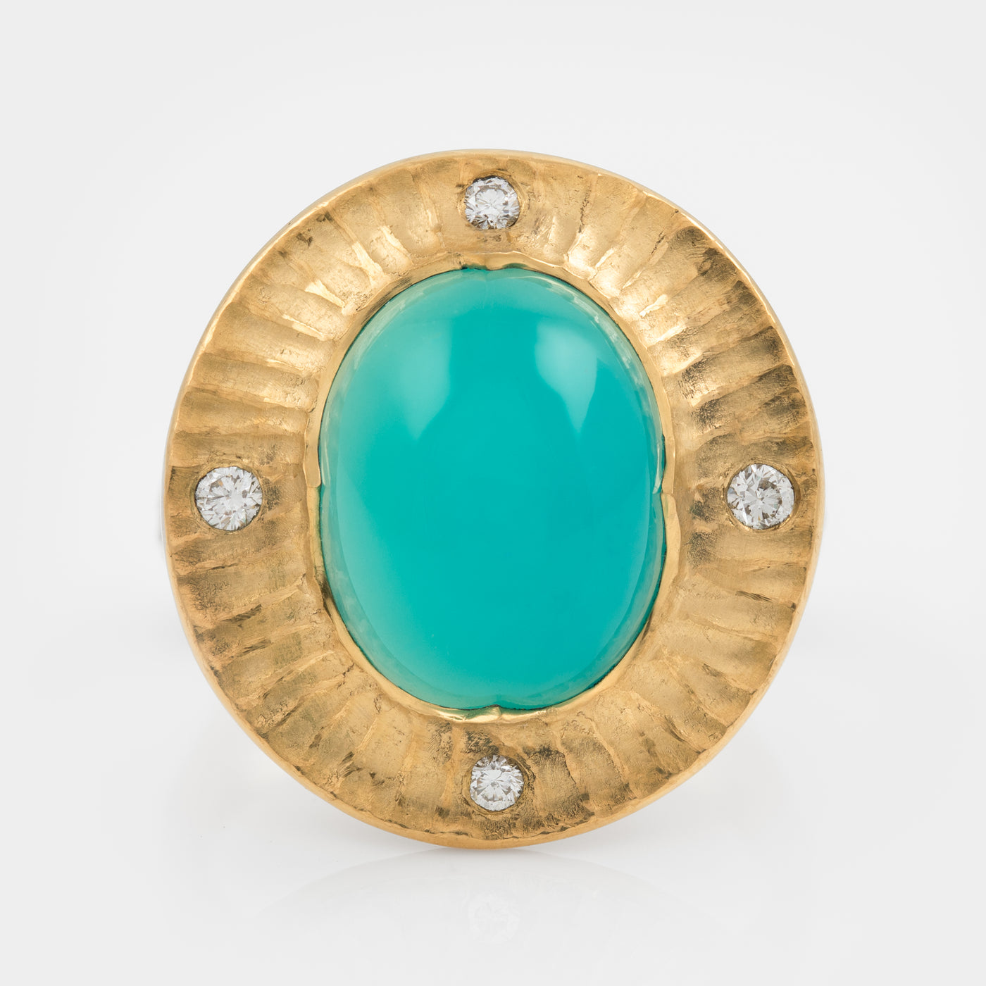 Gold ring with a chrysocolla gemstone and small diamonds on a white background
