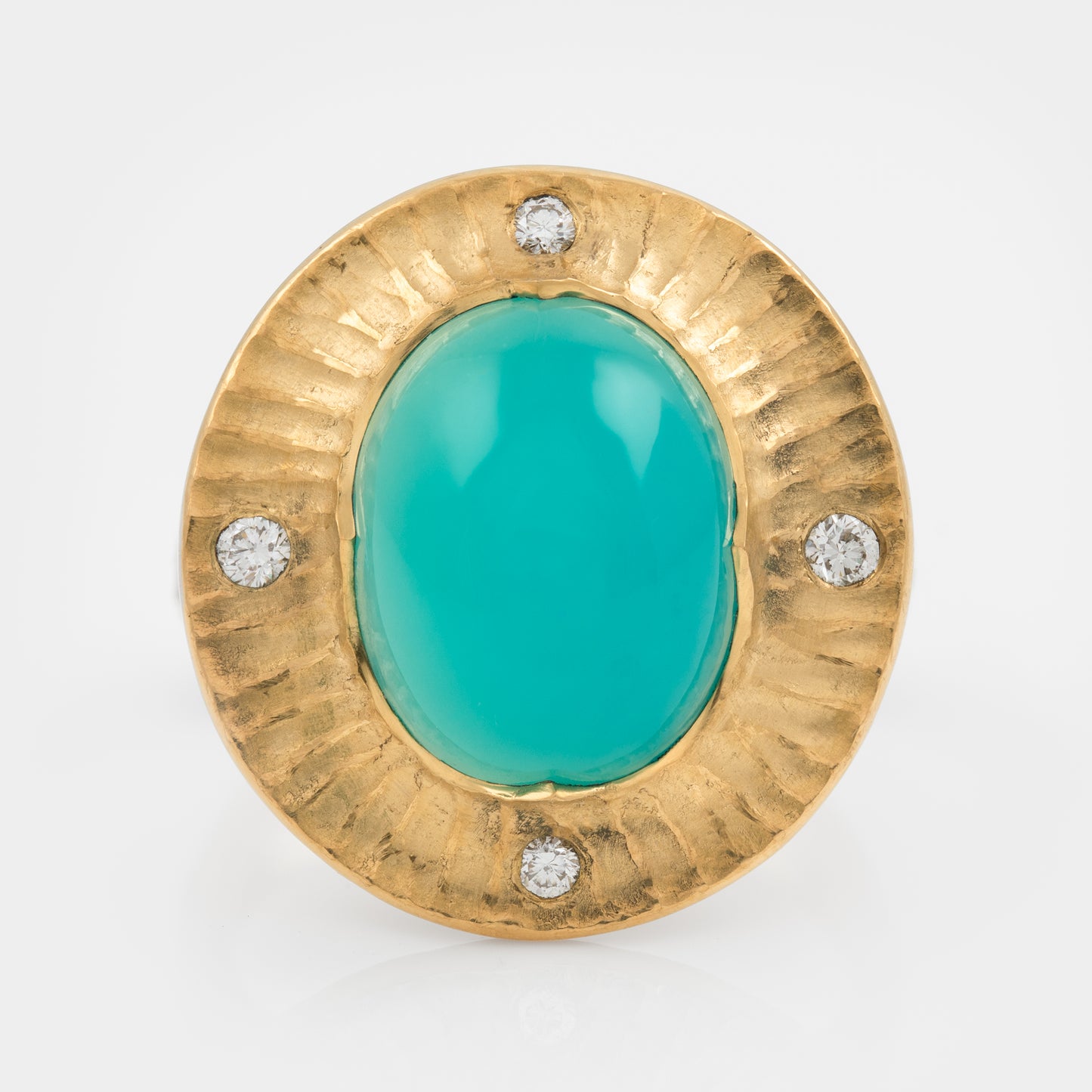 Gold ring with a chrysocolla gemstone and small diamonds on a white background