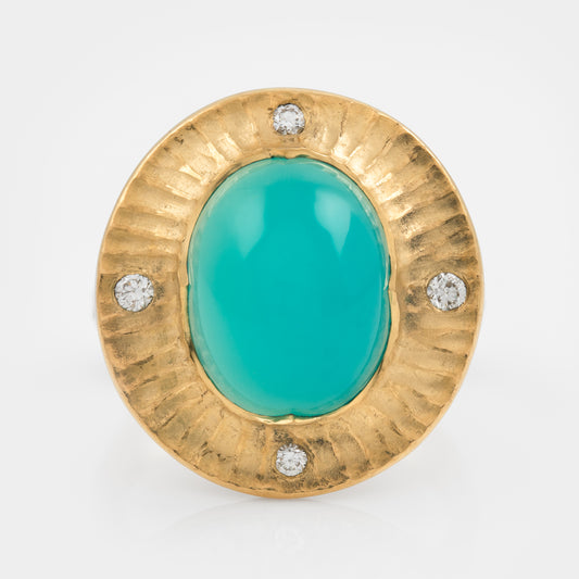 Gold ring with a chrysocolla gemstone and small diamonds on a white background