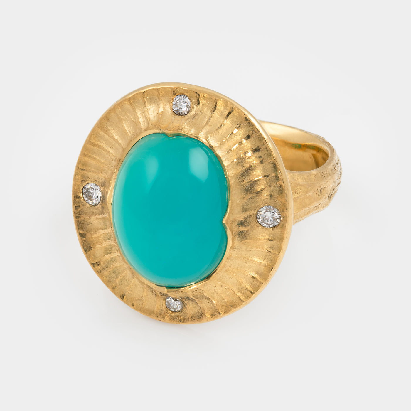 Gold ring with a chrysocolla gemstone and small diamonds on a white background, three-fourths angle