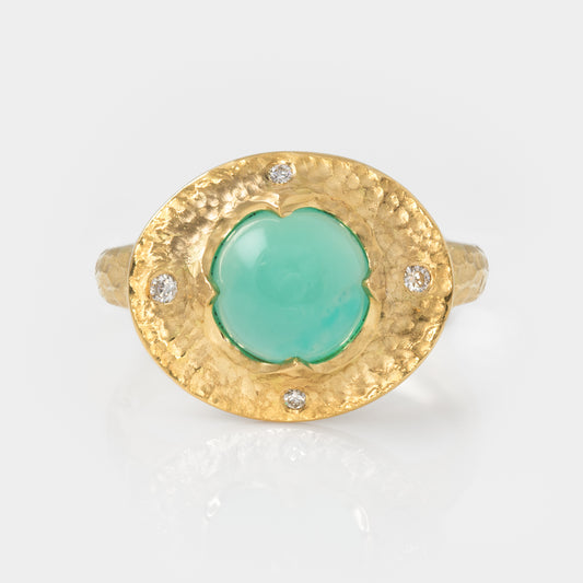 Gold ring with a chrysocolla gemstone and small diamonds on a white background